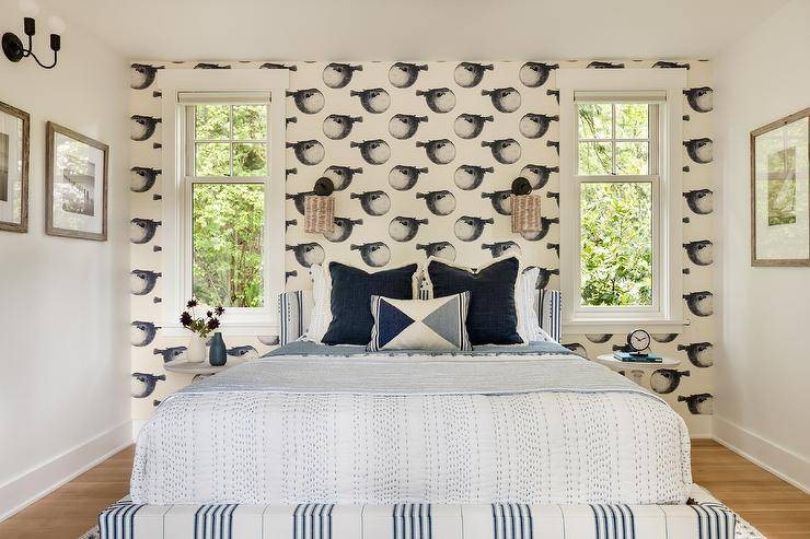 Bedroom features a low wingback blue stripe headboard with blue and white bedding and black and white Mr. Blowfish Wallpaper.