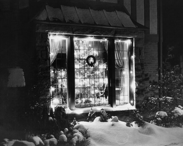 View of a living room from the outside on a snowy day