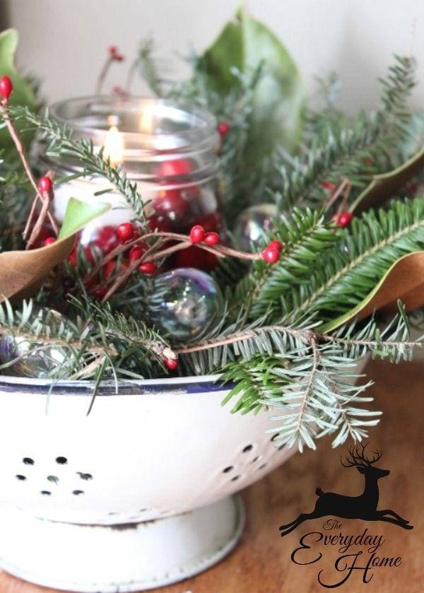 collander being used as candle holder in winter centerpiece for table