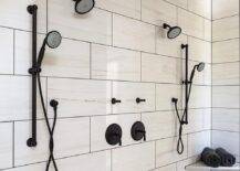 White lattice floor tiles accent a walk-in shower fitted with his and hers oil rubbed bronze shower kits mounted to large white offset wall tiles, a bronze rain shower head, and a corner floating bench.