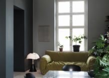 A cozy living room featuring a sleek marble table surrounded by two elegant chairs. The room exudes a warm ambiance with its tasteful decor and inviting atmosphere.