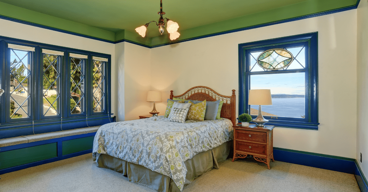 A white painted wall with green ceiling.