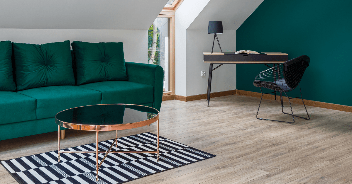 Luxurious emerald green furniture and accent wall.