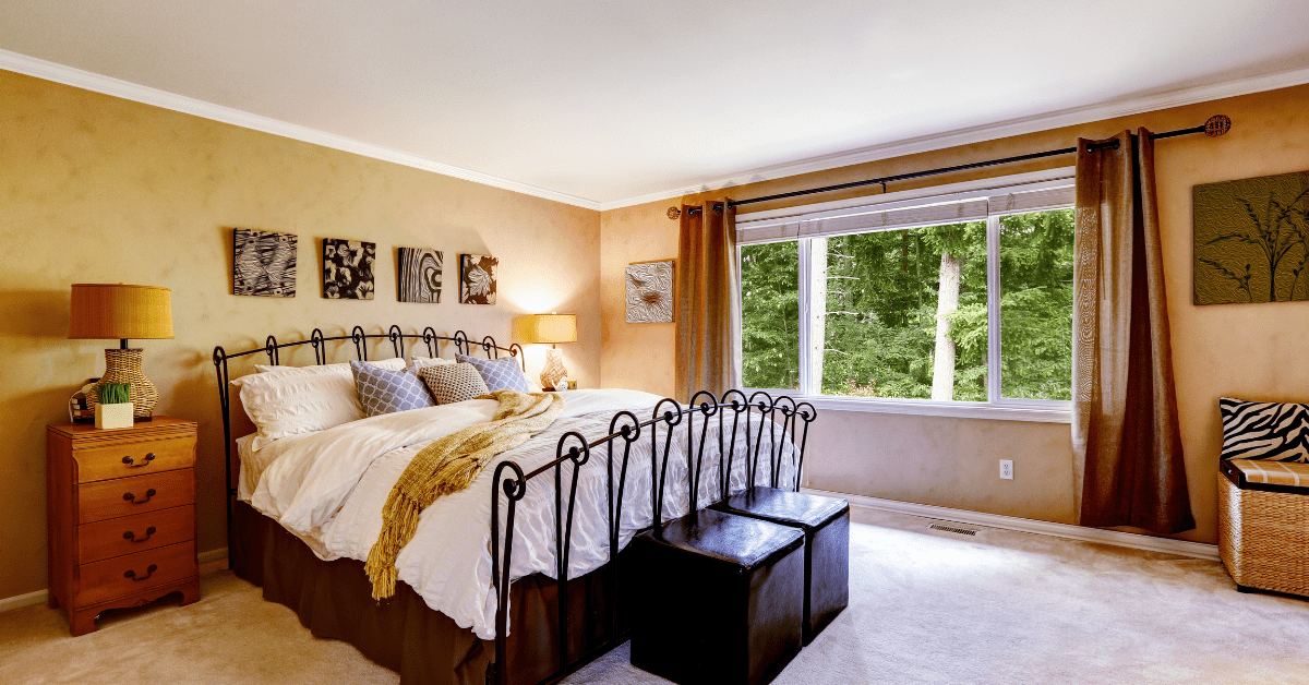 A soft bedroom with peachy-colored walls.