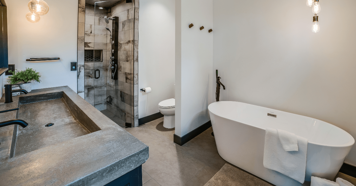 Ensuite bathroom with white tub and glass shower.