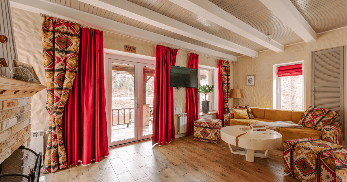 Contemporary Living Room Interior with Patterned Curtains, Cushions and Poufs.