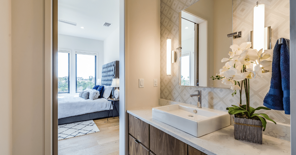 An ensuite bathroom flanked by bedroom.