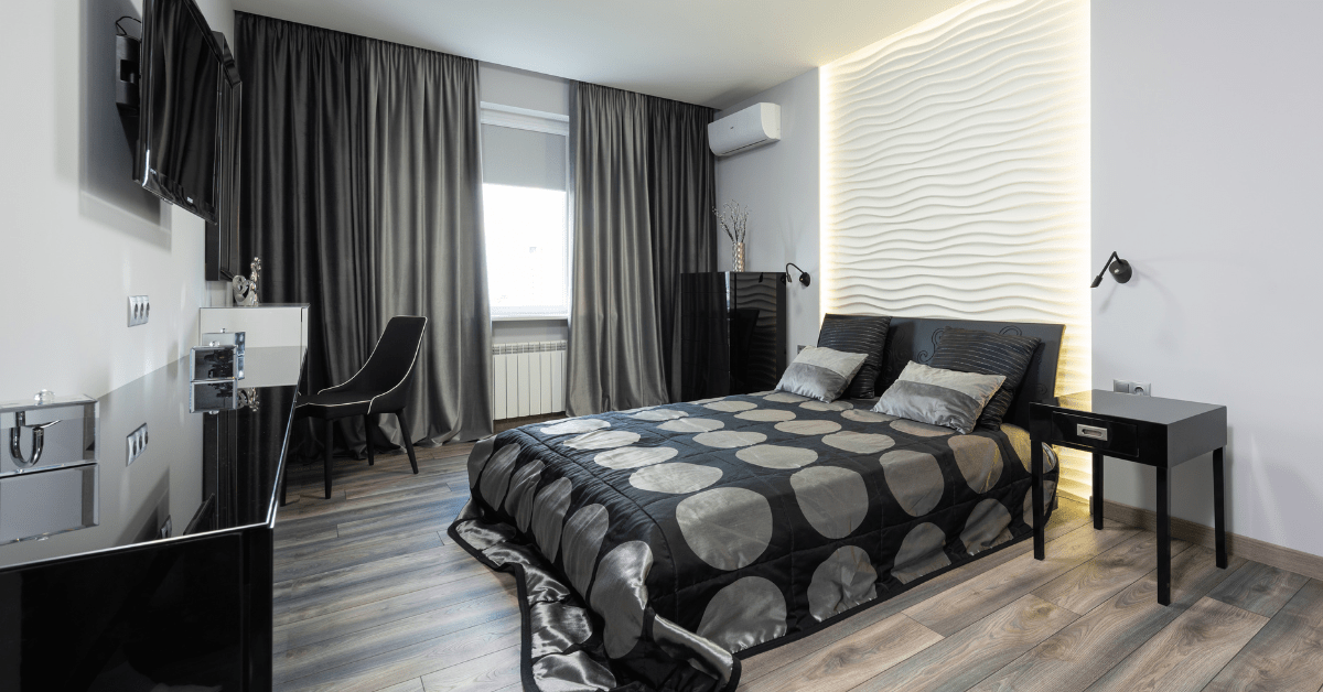 Patterned bed in a black bedroom.