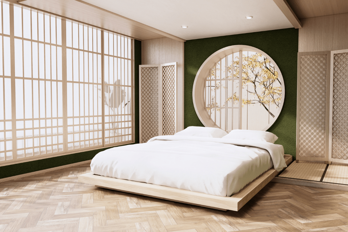 japanese bedroom with low bed large windows and green accent wall