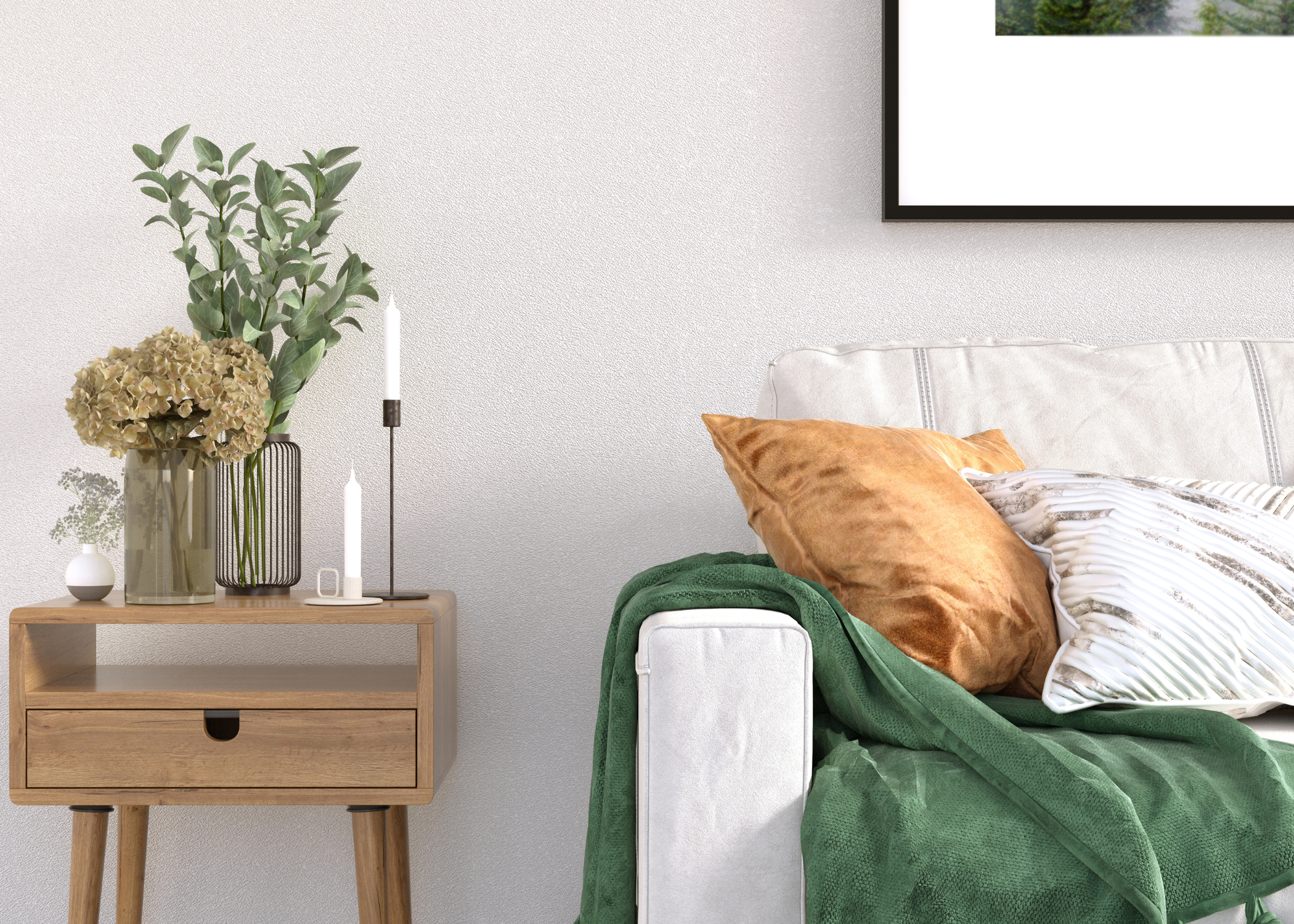 close up of living room couch with green throw and small side table with vases and florals