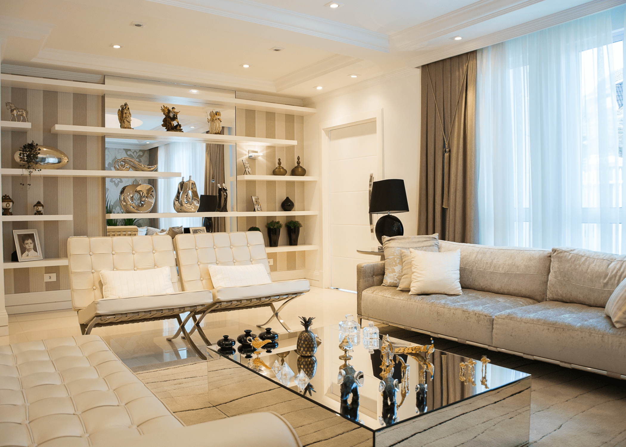 living room with open shelves leather chairs and couches