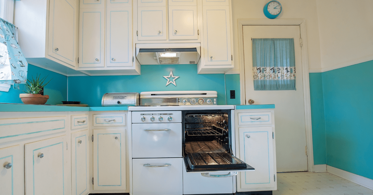 Retro white and blue kitchen with period correct decor.