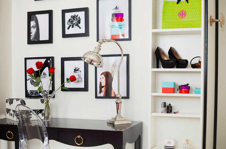 Chic girls bedroom with soft white wall color and floor to ceiling white cabinet with black trim. Bungalow 5 Jacqui Console Desk in Black faces a wall of framed photography with an adjustable desk lamp and trendy Ghost Chair.