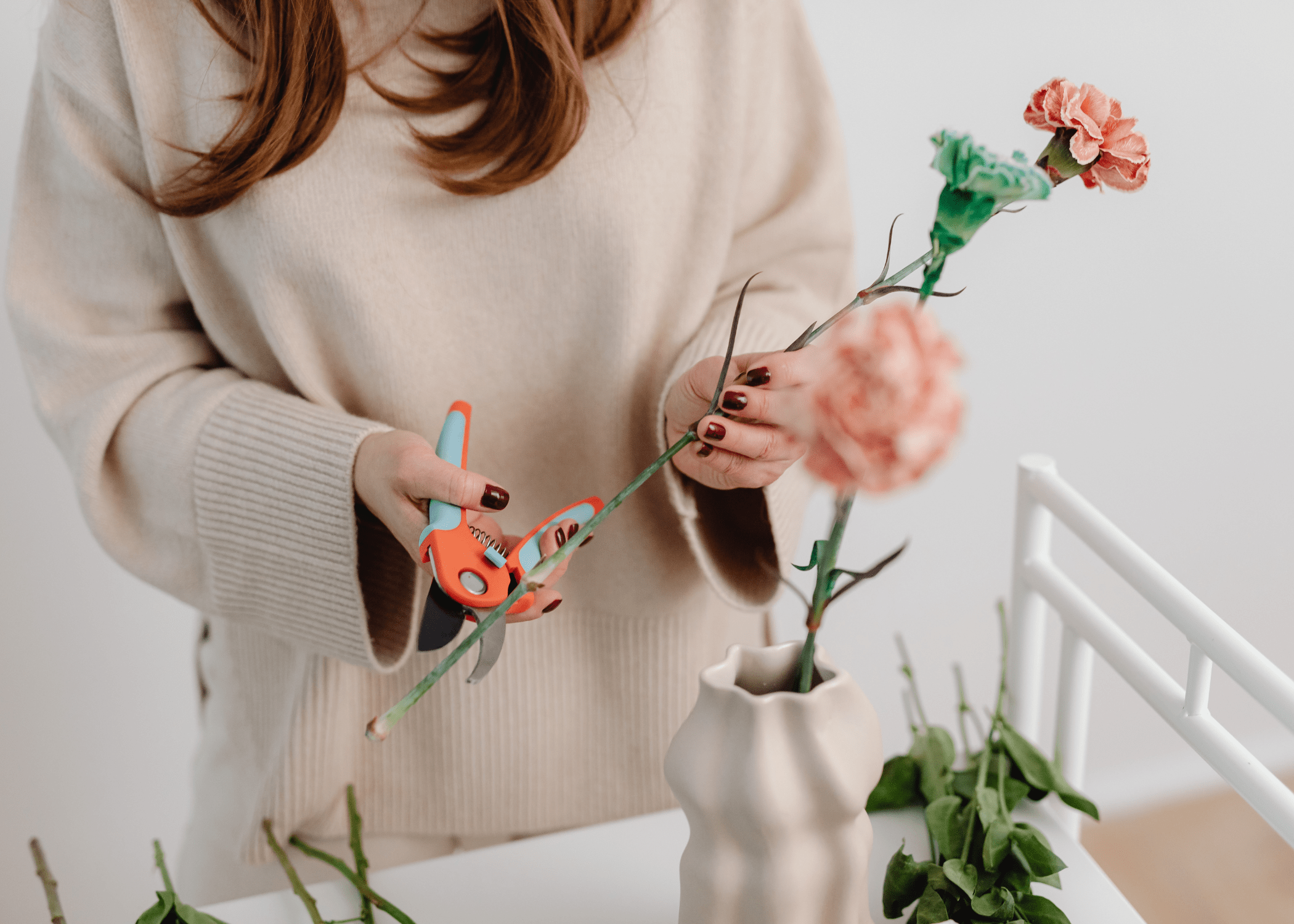 woman trimming floral stems