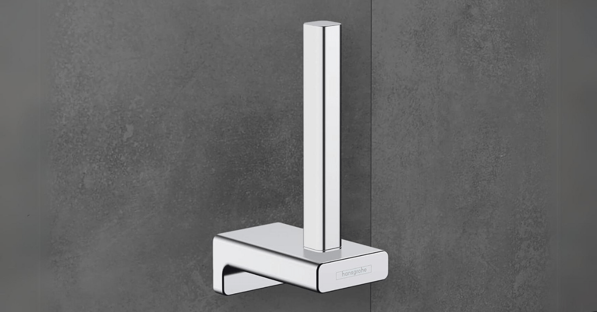 Vertical toilet paper holder in a dark bathroom.