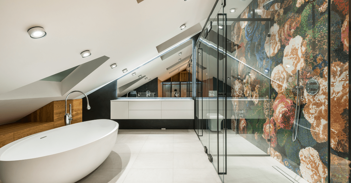 Modern wet room bathroom with sloped ceiling and glass walls.