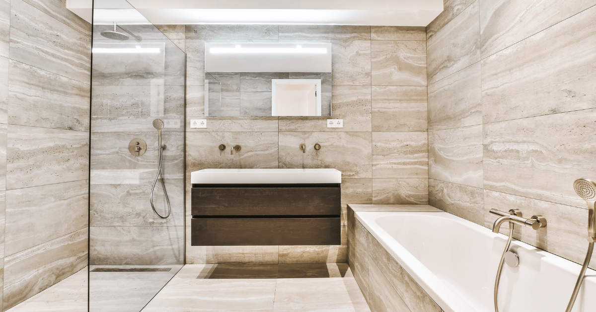 Modern wet room bathroom with large tile flooring and walls.