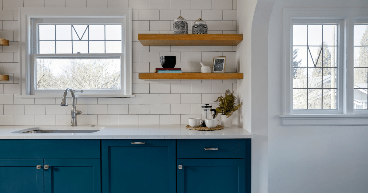 White kitchen with white tile backsplash.