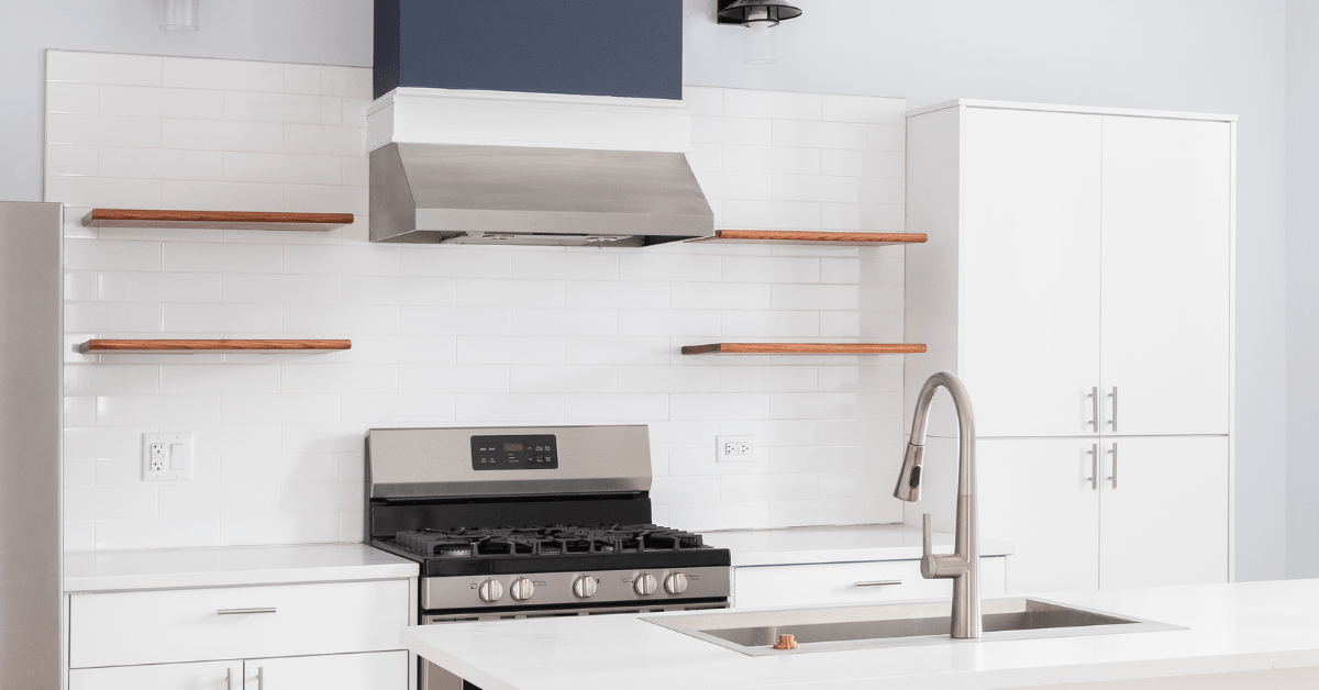 White kitchen with white tile backsplash.